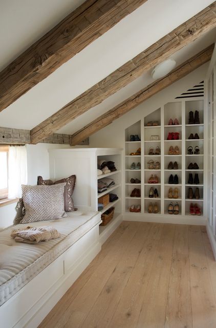 An image of built-in shoe storage within a loft conversion wardrobe