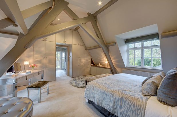 An image of a bedroom loft conversion with wooden beams