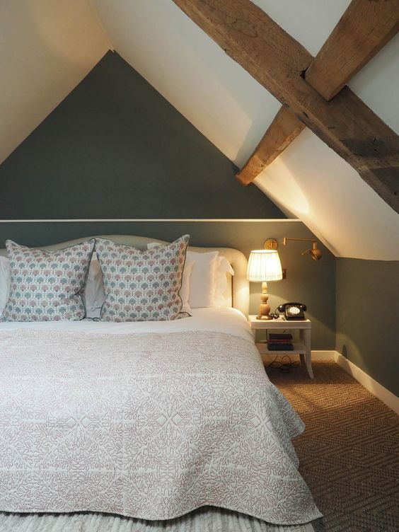 An image of a two-toned loft bedroom with wooden beams