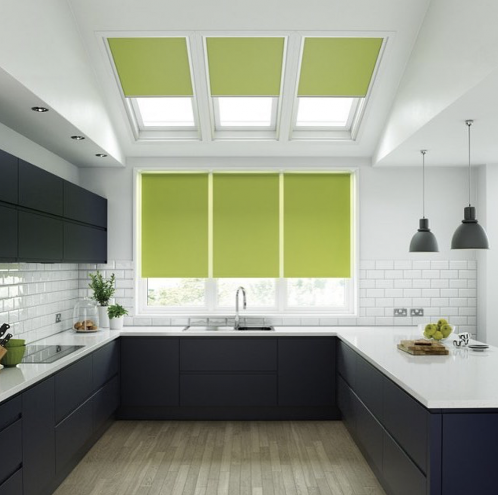 Lime green skylight blinds and roller blinds in a monochrome kitchen